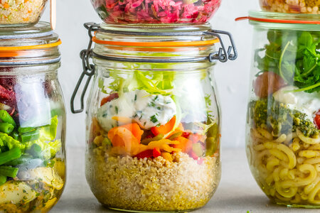 Jar with quinoa, organic sweet potato relish and fresh goat cheese